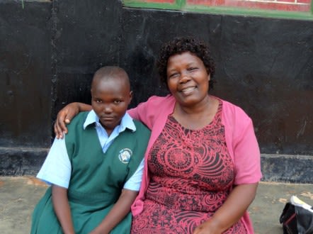 Kalibala with one of the children she supports in Uganda. - (Courtesy Galadys Kalibala)